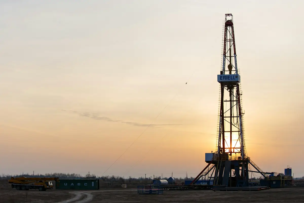 Drilling rig silhouetted at dusk