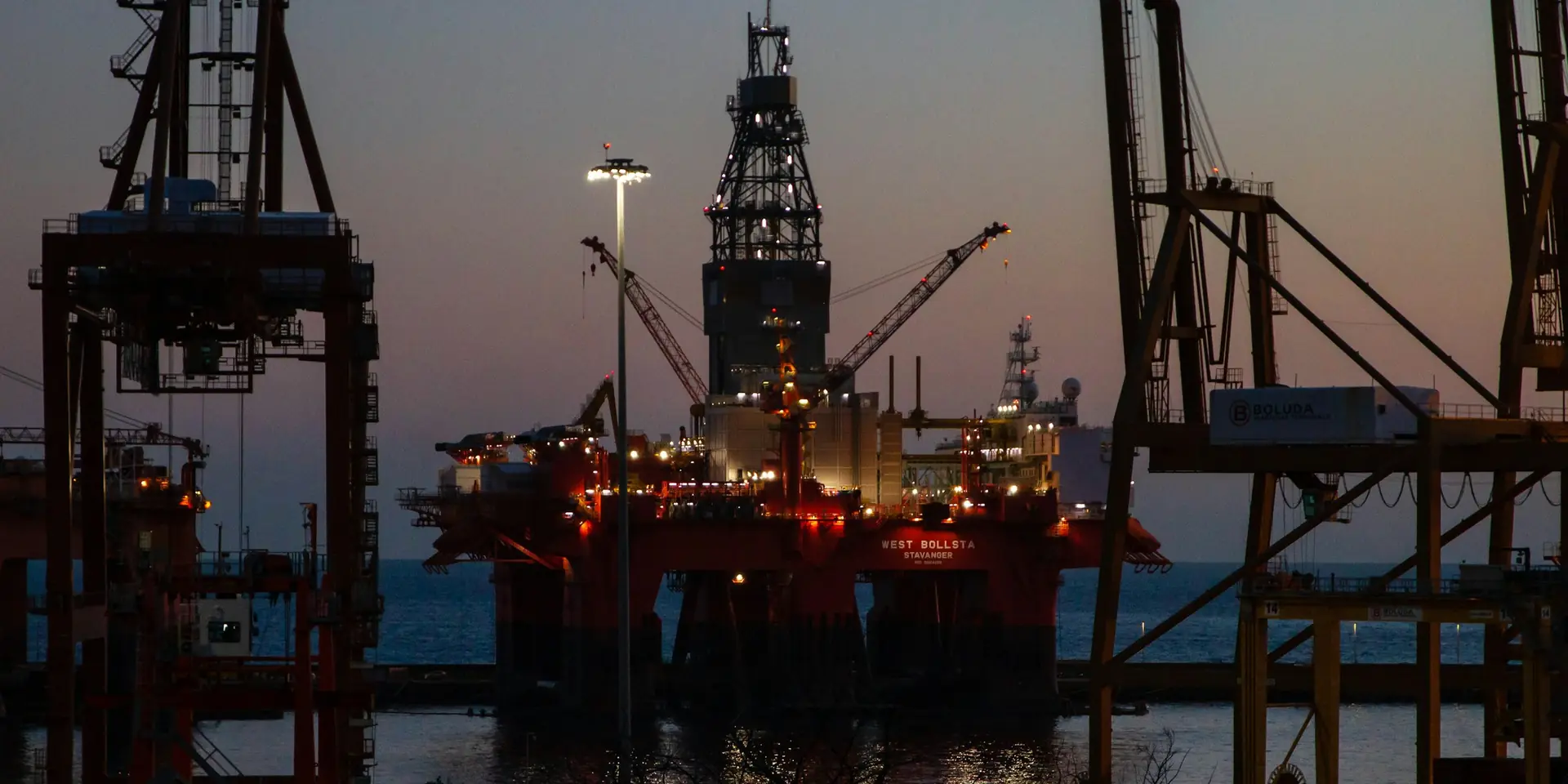 Offshore drilling rigs and platform at dusk